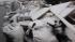 Snow covers debris piles as flood waters start...