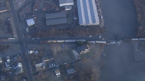 Train carrying chemicals derails into Del. River