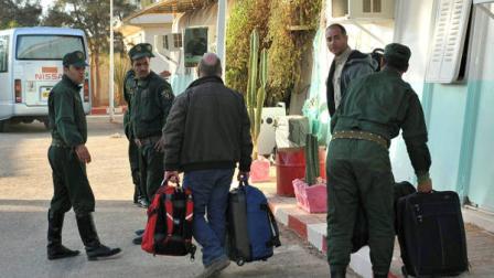 Two British hostages, Peter, right, and Alan, carrying his luggage, center, no family name available, gather their belongings after being released, in Ain Amenas, near the gas plant where they were kidnapped by Islamic militants, Saturday, Jan. 19, 2013. Algerias special forces stormed the natural gas complex in the middle of the Sahara desert in a final assault Saturday, killing 11 militants, but not before they, in turn, killed seven hostages, the state news agency reported. (AP Photo/Anis Belghoul)
