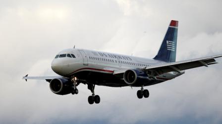 In this Friday, Oct. 29, 2010 photo, an US Airways jet airplane approaches Philadelphia International Airport in Philadelphia. (AP Photo/Matt Rourke)