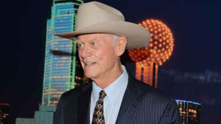 American actor, director and producer, Larry Hagman, best known for his role as J.R. Ewing from the TV series Dallas poses for a photo in front of a backdrop with an image of downtown Dallas, during a reception at the University of Texas at Tyler, following his presetation of Confessions on Nov. 10, 2012. Hagman, who for more than a decade played villainous patriarch JR Ewing in the TV soap Dallas, has died at the age of 81, his family said Saturday Nov. 24, 2012. (AP Photo/Dr. Scott M. Lieberman)