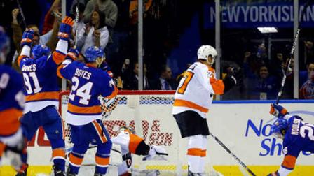 New York Islanders center John Tavares (91), Brad Boyes (24) and Matt Moulson (26) celebrate a goal by Tavares as Philadelphia Flyers goalie Steve Mason (35) and Bruno Gervais (27) look on during the third period of an NHL hockey game in Uniondale, N.Y., Tuesday, April 9, 2013. The Islanders won 4-1.(AP Photo/Paul J. Bereswill)