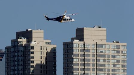 A New Jersey State Police helicopter flies over Jersey City, N.J., Monday, April 15, 2013. New Jersey is securing its city, which sits along the Hudson River across from New York City, in the wake of explosions near the finish line at the Boston Marathon.