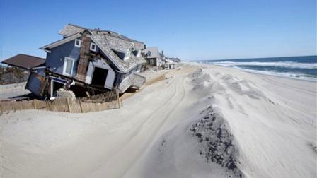 Homes severely damaged last October by Superstorm Sandy, are seen along the beach Thursday, April 25, 2013, in Mantoloking, N.J. Six months after Sandy devastated the Jersey shore and New York City and pounded coastal areas of New England, the region is dealing with a slow and frustrating, yet often hopeful, recovery. (AP Photo/Mel Evans)