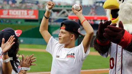 Chris Garcia reacts after being introduced before throwing out a ceremonial first pitch before a baseball game between the Washington Nationals and the Atlanta Braves at Nationals Park Tuesday, Aug. 6, 2013, in Washington.