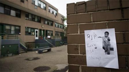 A flyer bearing an image of Antiq Hennis, the 1-year-old boy who was shot in his stroller during a walk with his parents, is posted on a wall outside an apartment complex, Monday, Sept. 1, 2013, in the Brownsville neighborhood in the Brooklyn borough of New York. New York Police Department investigators believe the boys father may have been the intended target and are pursuing leads. (AP Photo/John Minchillo)