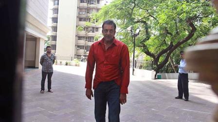 Bollywood actor Sanjay Dutt, center, stands outside his home after being temporally freed for two weeks from an Indian prison in Mumbai, India, Tuesday, Oct.1, 2013. The 54-year-old actor is currently serving five years in prison for illegal possession of weapons linked to Mumbais 1993 terror attack. (AP Photo)