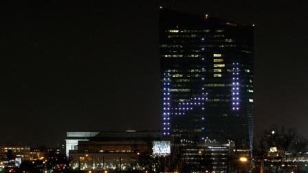 The classic Atari video game Pong is played on the facade of the Cira Center in Philadelphia on Friday April 19, 2013. Hundreds of built-in LED lights embedded in the north face of the Cira Centre were used to replicate the familiar paddles and ball with gamers controlling giant, table-mounted joysticks across the Schuylkill River from the building. (AP Photo/ Joseph Kaczmarek)