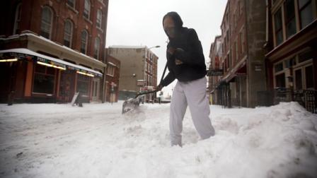 A restaurant worker shovels as mixed winter precipitation falls Thursday, Feb. 13, 2014, in Philadelphia. Snow and sleet are falling on the East Coast, from North Carolina to New England, a day after sleet, snow and ice bombarded the Southeast. (AP Photo/Matt Rourke)