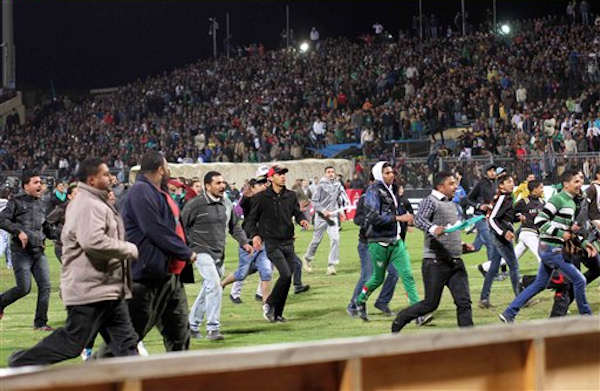Egyptian fans celebrate their teams win before...