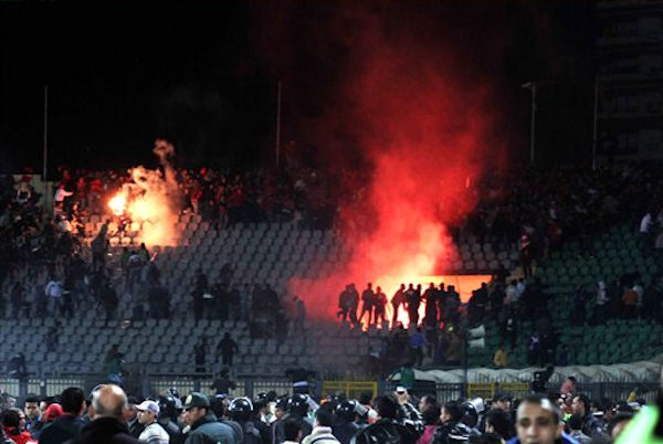 Egyptian fans celebrate their teams win before...