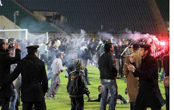 Egyptian fans celebrate their teams win before...
