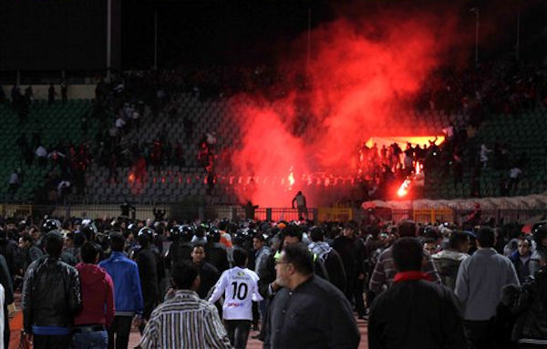 Egyptian fans celebrate their teams win before...