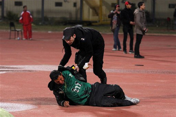 Egyptian fans celebrate their teams win before...