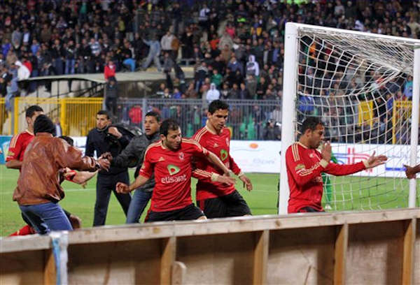 Egyptian fans celebrate their teams win before...
