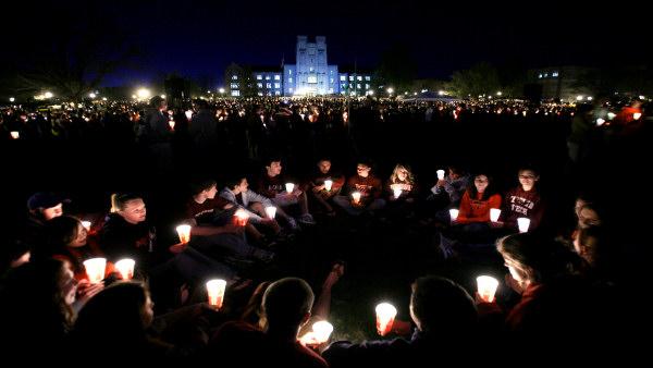 Students and mourners form a circle and hold candles as they participate in a candle light vigil marking the first anniversary of the April 16, 2007 shootings on the campus of Virginia Tech in Blacksburg, Va., Wednesday, April 16, 2008. (AP Photo/Steve Helber)