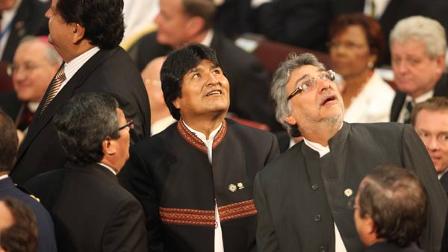 Paraguays President Fernando Lugo, right, next to Bolivias President Evo Morales, center, look up as they react during a aftershock.