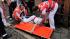An injured reveler, is helped by Spanish Red...