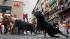 Revelers run on the Estafeta corner as a...