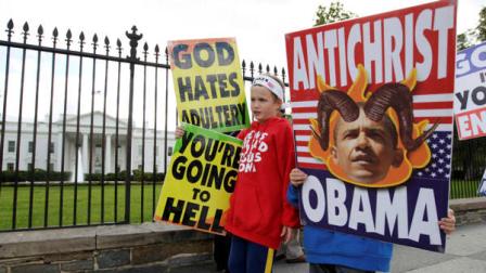 Members of the Westboro Baptist Church, Luke Phelps-Roper, 8, left, and Seth Phelps, 9, both from Topeka, Kansas, picket outside the White House in Washington, Tuesday, Oct. 5, 2010.