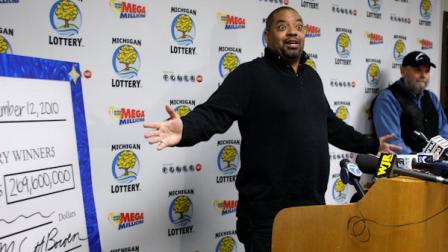 Mike Greer talks about his Team Victory groups $128.6 million winning lottery ticket during a news conference Friday, Nov. 12, 2010, in Lansing, Mich. A $129 million Powerball lottery ticket sold at an urban porn shop is being split by members of a group primarily from southeast Michigan. (AP Photo/Al Goldis)