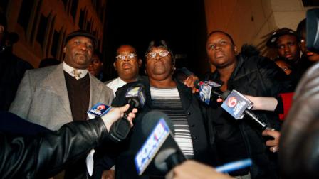 Edna Glover, center, mother of Henry Glover, who police were alleged to have shot and later burned his body in a car in the aftermath of Hurricane Katrina, talks to reporters with family and supporters outside the courthouse after a jury reached a split verdict against the men in New Orleans, Thursday, Dec. 9, 2010. (AP Photo/Gerald Herbert)