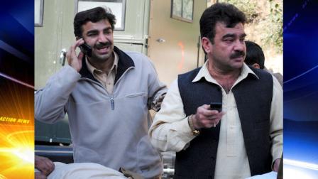 Pakistani men weep as they stand beside their relative who was injured in the suicide bombing in Bajur tribal region, at Lady Reading hospital in Peshawar, Pakistan on Saturday, Dec. 25, 2010. A female suicide bomber detonated her explosives-laden vest in a crowded aid distribution center in northwest Pakistan on Saturday, killing at least 41 people and wounding dozens waiting for food stamps, officials said. (AP Photo/Mohammad Sajjad)