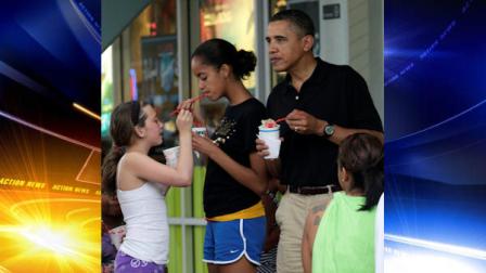 FILE - In this Dec. 27, 2010 file photo, President Barack Obama, right, his daughter Malia, second from right, and family and friends eat Shave Ice at Island Snow at Kailua Beach Center while on vacation with the first family in Kailua, Hawaii. (AP Photo/Carolyn Kaster, File)