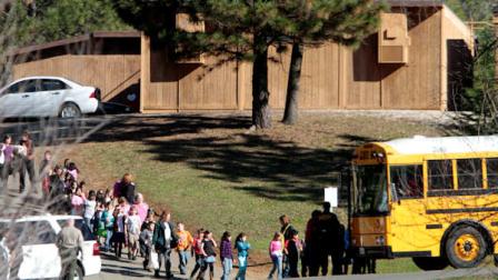 Students from the Louisiana Schnell School board a bus after a shooting took place at the school in Placerville, Calif., Wednesday, Feb. 2, 2011. Principal Sam LaCara died after allegedly being shot by the schools janitor, John Leubbers, who was taken into custody about an hour after the shooting. No children were injured in the incident. The children were taken to the nearby fairgrounds to be reunited with their loved ones.(AP Photo/Rich Pedroncelli)