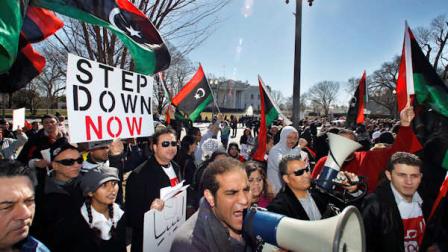 Hossam Mansour, center, joins protestors waving Libyan flags gathered in front of the White House in Washington, Saturday, Feb. 19, 2011, to call for the ouster of Libyan leader Moammar Gadhafi. Gadhafis forces fired on mourners leaving a funeral for protesters Saturday in the eastern city of Benghazi, killing at least 15 people and wounding scores more as the regime tried to squelch calls for an end to the rulers 42-year grip on power. (AP Photo/Manuel Balce Ceneta)