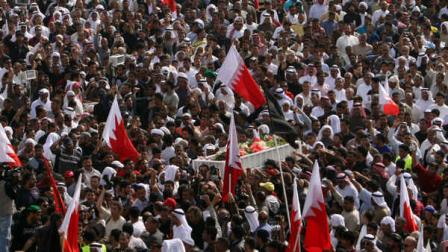 Some thousands of Bahraini mourners participate in a funeral march Tuesday, Feb. 22, 2011, in Malkiya, Bahrain, for Redha Bu Hameed, who died during clashes between army forces and anti-government protesters.