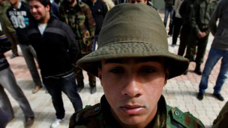 New Libyan rebel recruits stand in formation during a training session after signing up with the forces against Libyan leader Moammar Gadhafi at a training base in Benghazi, eastern Libya, on Thursday March 3, 2011. Rebel forces routed troops loyal to Moammar Gadhafi in a fierce battle over an oil port Wednesday, scrambling over the dunes of a Mediterranean beach through shelling and an airstrike to corner their attackers. While they thwarted the regimes first counteroffensive in eastern Libya, opposition leaders still pleaded for outside airstrikes to help them oust the longtime leader.