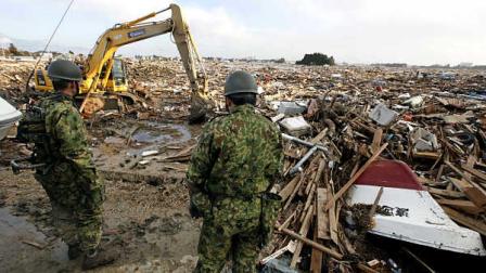 Japan Ground Self-Defense Force personnel conduct a search operation following the March 11 earthquake triggered tsunami at Natori, Miyagi Prefecture, Japan, Wednesday, March 16, 2011.
