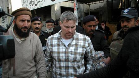 FILE - In this Jan. 28, 2011, file photo, Pakistani security officials escort Raymond Allen Davis, center, to a local court in Lahore, Pakistan. Officials say on Wednesday, March 16, 2011 an American CIA contractor detained on suspicion of murder has been released after families of the two Pakistanis he killed pardoned him in exchange for compensation. Davis has been in jail since Jan. 27, seriously straining ties between Pakistan and the United States.