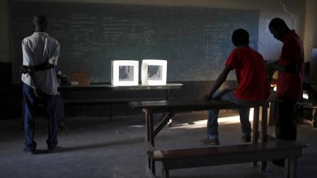 Electoral workers wait for voters at a polling station during a presidential runoff in Port-au-Prince, Haiti, Sunday, March 20, 2011. Haitis voters will choose between candidates Mirlande Manigat, the former first lady, and Michel Sweet Micky Martelly, a star of Haitian music to lead the country. (AP Photo/Alexandre Meneghini)