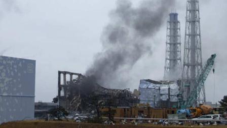 In this photo released by Tokyo Electric Power Co. (TEPCO), gray smoke rises from Unit 3 of the tsunami-stricken Fukushima Dai-ichi nuclear power plant in Okumamachi, Fukushima Prefecture, Japan, Monday, March 21, 2011. Official says the TEPCO temporarily evacuated its workers from the site. At left is Unit 2 and at right is Unit 4.