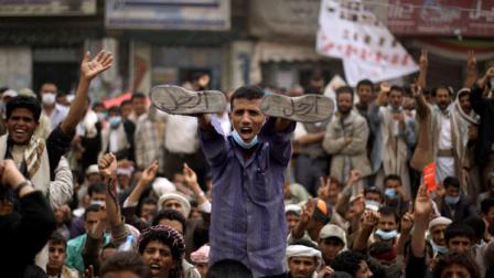 An anti-government protestor, center, displays his shoes with markings in arabic read, Leave, during a demonstration demanding the resignation of Yemeni President Ali Abdullah Saleh, in Sanaa,Yemen, Monday, March 28, 2011. Yemens president, clinging to power despite weeks of protests, scrapped an offer to step down by years end on Sunday, as Islamic militants taking advantage of the deteriorating security took control of another southern town.