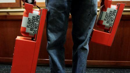 The flight recorders from Southwest flight 188 that experienced a rapid decompression and made an emergency landing in Yuma, Ariz., Friday, April 1, 2011, is carried by National Transportation Safety Board Aerospace Engineer Chris Babcock to the National Transportation Safety Board headquarters in Washington, Saturday, April 2, 2011. (AP Photo/Manuel Balce Ceneta)