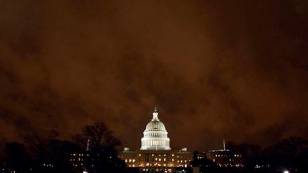 Lights burn in the US Capitol under storm clouds illuminated by the city lights late Friday, April 8, 2011, when Congress reached a budget compromise to keep the government funded. (AP Photo/J. David Ake)