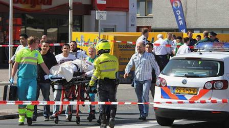 Injured people are carried out of a shopping mall after a shooting in Alphen aan den Rijn, 15 miles (25 kilometers) southwest of Amsterdam, Netherlands, Saturday, April 9, 2011. A gunman opened fire with an automatic weapon at a shopping mall outside Amsterdam on Saturday, leaving at least four people dead and wounding 16 others, Dutch officials said.