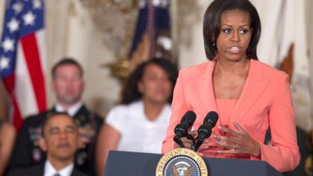 President Barack Obama looks on as First lady Michelle Obama speaks in the East Room of the White House on Tuesday, April 12, 2011, during the launch the national initiative to support and honor Americas service members and their families. Retired Gen Stanley McChrystal, the former top US general in Afghanistan who was relieved of his duty last year , has been chosen to help lead the new initiative. (AP Photo/Evan Vucci)