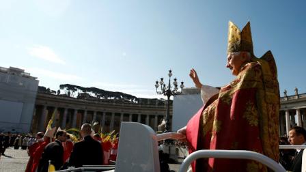 Pope Benedict XVI delivers his blessing as he arrives to celebrate a Palm Sunday mass in St. Peters square, at the Vatican, Sunday, April 17, 2011. (AP Photo/Andrew Medichini)