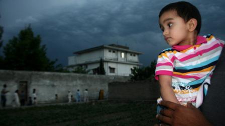 A Pakistani child seen in front of the compound of al-Qaida leader Osama bin Laden in Abbottabad, Pakistan, Wednesday, May 4, 2011. The residents of Abbottabad, Pakistan, were still confused and suspicious on Wednesday about the killing of Osama bin Laden, which took place in their midst before dawn on Monday. (AP Photo/Aqeel Ahmed)