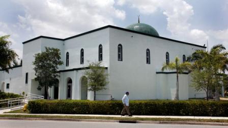 A pedestrian walks past the Jamat Al-Mummineen Mosque in Margate, Fla., where imam Izhar Khan has been charged with providing about $45,000 in financial support to the Pakistani Taliban Saturday, May 14, 2011. (AP Photo/Jeffrey M. Boan)