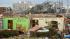 A damaged home is spray-painted with messages of...
