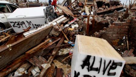 Family members of Bob and Darlene Jordan family look through for belongings in the couples devastated Joplin, Mo. home Friday, May 27, 2011. The Jordans were missing and thought by family to be dead, until they turned up Tuesday in a Pittsburg, Kan. hospital. An EF-5 tornado tore through much of the city Sunday, damaging a hospital and hundreds of homes and businesses and killing at least 126 people. (AP Photo/Charlie Riedel)