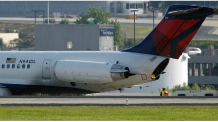 A Delta Air Lines jet sits at Atlantas Hartsfield Jackson International Airport after firefighters say four people sustained minor injuries when the jet blew at least one tire landing and suffered an engine fire Saturday, May 28, 2011 in Atlanta. (AP Photo/David Goldman)