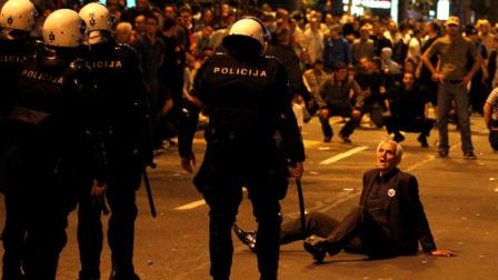 A men sits on the ground as members of the riot police approach him after a rally organized by the ultranationalist Serbian Radical Party in front of the Parliament building, in Belgrade, Serbia, on Sunday, May 29, 2011. Mladic was arrested on Thursday in a village in Serbia after 16 years on the run.