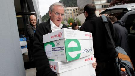 A reporter carries boxes containing thousands of pages of Sarah Palins emails from her time as Alaskas governor Friday, June 10, 2011 in Juneau, Alaska. The emails released by the state of Alaska Friday were first requested during the 2008 White House race by citizens and news organizations, including The Associated Press. (AP Photo/Brian Wallace)