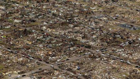 FILE - In this May 24, 2011 file photo, a destroyed neighborhood is seen in Joplin, Mo., after a large tornado moved through much of the city. In the aftermath of the tornado, some people injured in the storm have developed a rare and sometimes fatal fungal infection so aggressive that it turned their tissue black and caused mold to grow inside their wounds. Scientists say the unusually aggressive infection occurs when dirt or vegetation becomes embedded under the skin. (AP Photo/Charlie Riedel, File)